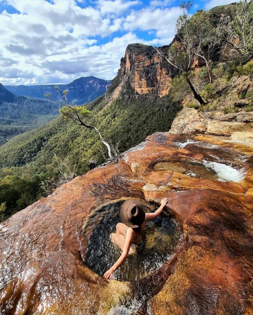 A traveler overlooking a breathtaking canyon landscape during a luxury guided tour.